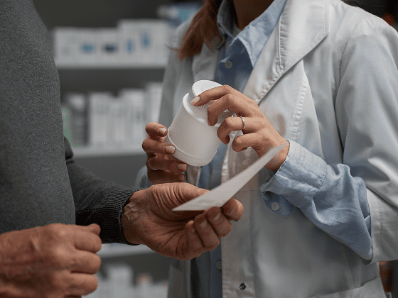 Pharmacist reviewing prescription and medication for medication management psychiatry.